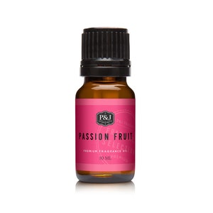 May include: A small amber glass bottle with a black cap, containing Passion Fruit fragrance oil. The label is pink with white text that reads "P&J Trading, Passion Fruit, Premium Fragrance Oil, 10 ml".
