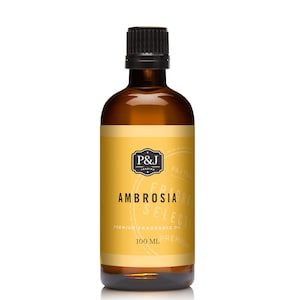 May include: A brown glass bottle with a black cap, containing a yellow liquid. The label reads "P&J Trading", "Ambrosia Select", "Premium Fragrance Oil", and "100 ML Premium".