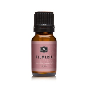 May include: A brown glass bottle with a black cap, containing a 10 ml bottle of Plumeria fragrance oil. The label is pink with white text and a logo.