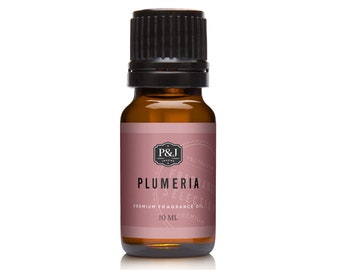 May include: A brown glass bottle with a black cap, containing a 10 ml bottle of Plumeria fragrance oil. The label is pink with white text and a logo.