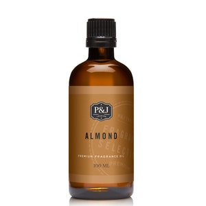 May include: A brown glass bottle with a black cap, containing almond fragrance oil. The label is brown with white text that reads "P&J Trading", "Fragrance Selection", "Almond", "Premium Fragrance Oil", and "100 ml".