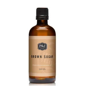 May include: A brown glass bottle with a black cap, labeled "Brown Sugar" and "Premium Fragrance Oil". The bottle contains 100 ml of fragrance oil.