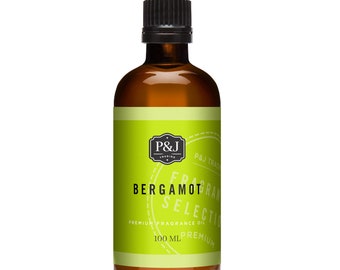 May include: A 100 ml amber glass bottle of Bergamot fragrance oil. The bottle has a black cap and a green label with the text "P&J Trading", "Bergamot Select", "Premium Fragrance Oil", and "100 ml".