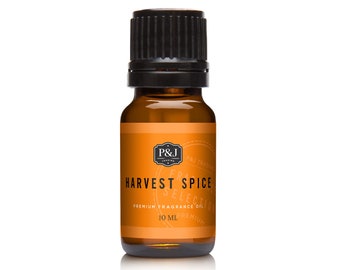 May include: A small amber glass bottle with a black cap, containing Harvest Spice Premium Fragrance Oil. The label is orange with black text and a logo.