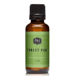 May include: A 30 ml bottle of Forest Pine fragrance oil. The bottle is amber glass with a black cap. The label is green with white text that reads "P&J Trading", "Forest Pine", "Premium Fragrance Oil", and "30 ml".