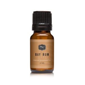 May include: A small amber glass bottle of Bay Rum fragrance oil. The bottle has a black cap and a label with the text "Bay Rum" and "Premium Fragrance Oil". The bottle contains 10 ml of oil.