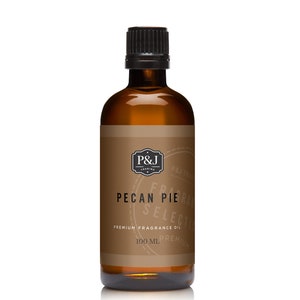 May include: A brown glass bottle with a black cap, labeled "Pecan Pie" and "Premium Fragrance Oil". The bottle contains 100 ml of fragrance oil.