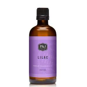 May include: A brown glass bottle with a black cap, containing lilac scented fragrance oil. The label is purple with white text that reads "P&J Trading", "Fragrance Selection", "Lilac", "Premium Fragrance Oil", and "100 ml".