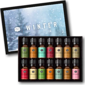 May include: A set of 12 small glass bottles with brown lids, each containing a different scented oil. The bottles are arranged in a black box with a white background that says "WINTER FRAGRANCE COLLECTIONS". The scents include Christmas Wreath, Apple Cider, Chocolate Mint, Cranberry, French Vanilla, Gingerbread, Coffee Cake, Candy Cane, Sugar Cookie, Mistletoe, Harvest Spice, Winter Mint, Cinnamon, and Peppermint.