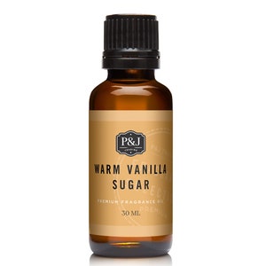 May include: A brown glass bottle with a black cap, labeled "Warm Vanilla Sugar" and "Premium Fragrance Oil". The bottle contains 30 ml of fragrance oil.