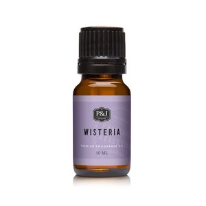 May include: A small amber glass bottle with a black cap, containing Wisteria scented fragrance oil. The label is purple with white text that reads "Wisteria Premium Fragrance Oil 10 ML".