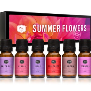 May include: A set of six 10 ml bottles of essential oil in a box. The bottles are labeled with the names of summer flowers: Sweet Pea, Azalea, Lilac, Red Poppy, Plumeria, and Verbena. The box has a floral design and the words "Summer Flowers" printed on it.