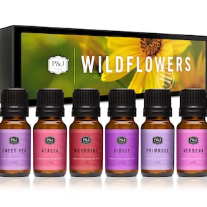 May include: A set of six 10 ml bottles of essential oil in a box with a sunflower image and the text "Wildflowers Fragrance Collection". The bottles are labeled with the names of different flowers: Sweet Pea, Azalea, Woodbine, Violet, Primrose, and Verbena.