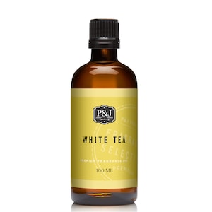 May include: A brown glass bottle with a black cap, containing a white tea fragrance oil. The label is yellow with black text that reads "P&J Trading", "White Tea", "Premium Fragrance Oil", and "100 ml Premium".