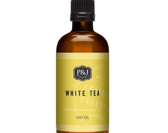 May include: A brown glass bottle with a black cap, containing a white tea fragrance oil. The label is yellow with black text that reads "P&J Trading", "White Tea", "Premium Fragrance Oil", and "100 ml Premium".