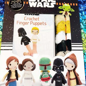 May include: A Star Wars crochet finger puppet kit. The kit includes a book and yarn to make 10 characters, including Luke Skywalker, Darth Vader, and Yoda. The box features the Star Wars logo and the text "Crochet Finger Puppets."