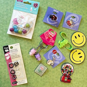 May include: Assortment of colorful craft supplies including beads, charms, and keychains.  The items are arranged on a green surface.  The packaging includes the text "claire's" and "best friends".