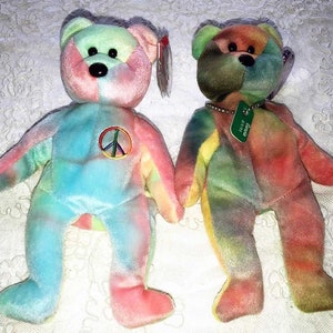 May include: Two tie-dye beanie babies, one blue and pink with a peace sign and the other green, yellow, and orange with a tag that says "Grateful".