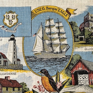 May include: A vintage linen textile featuring a nautical theme with illustrations of a sailboat, lighthouse, and a bird. The textile includes text that reads "USCG Barque Eagle", "Saybrook Lighthouse", and "Gillette Castle".