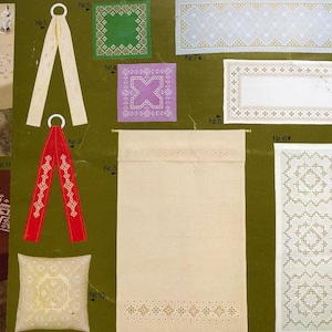 May include: A collection of 11 embroidery patterns for tablecloths, runners, and other home decor items. The patterns feature various geometric designs in white and gold thread on a white linen background. The patterns are numbered 1 through 11.