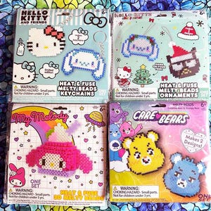 May include: Four packages of colorful bead kits featuring Hello Kitty, My Melody, Care Bears, and a Christmas-themed Hello Kitty design. Each package includes instructions and beads to create a keychain or ornament. The packages are labeled "Heat & Fuse Melty Beads" and include warnings about choking hazards.