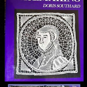 May include: A book titled "Bobbin Lacemaking" by Doris Southard. The cover is purple with white text. A black square features a white lace portrait of a person. The book's spine is visible at the bottom, showing the title.
