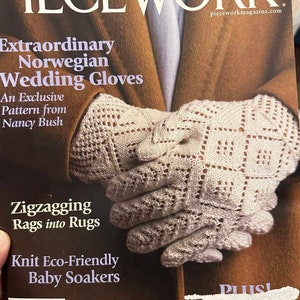 May include: The cover of PieceWork magazine features a pair of cream-colored, open-weave gloves. The gloves are the focus, with the magazine's title and articles about knitting and crafts in the background. The magazine's title is in large white letters.