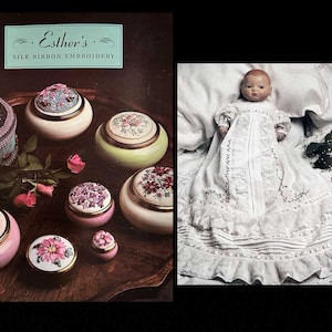 May include: An image featuring a collection of decorative trinket boxes with floral designs and a doll in a white dress. The boxes are in various colors, including pink, green, and white, with gold rims. The doll is lying on a white surface.