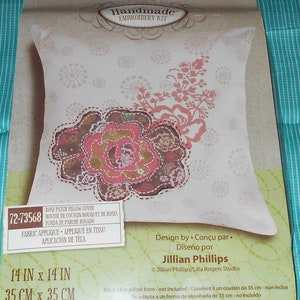 May include: A handmade embroidery kit for a rose patch pillow cover. The kit includes a 14-inch by 14-inch pillow form, fabric applique, and instructions. The design is by Jillian Phillips.