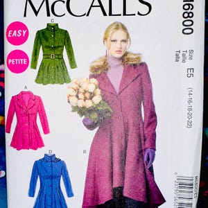 May include: McCall's sewing pattern M6800 featuring coat designs. The pattern includes illustrations of a green belted coat, a pink double-breasted coat, and a blue coat with a high collar. The size is E5 (14-16-18-20-22).