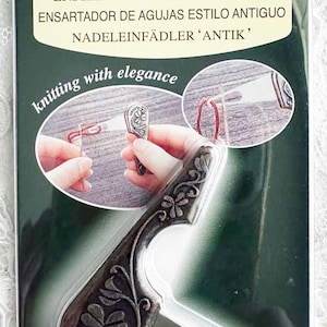 May include: An antique yarn threader by Clover. The package features a silver-colored threader with a decorative floral design. The text on the package includes "Antique Yarn Threader" in multiple languages, and the Clover logo.