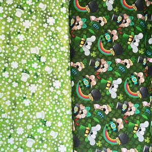 May include: Two green fabric swatches with different patterns. The left swatch has a white shamrock and hat pattern on a green background. The right swatch has a green, black, and white dog wearing a green hat and holding a rainbow pattern on a green background.