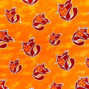 May include: Orange fabric with a repeating pattern of red cartoon cats wearing hats. The cats are facing left and have white eyes and a white nose. The fabric has a distressed look.