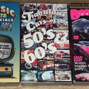 May include: Three VHS tapes with images of classic cars and sports commercials. The first tape is titled "Classic Sports Commercials from the 50's & 60's" and features a vintage television with a baseball player on the screen. The second tape is titled "Fabulous Cars of the 50's & 60's" and features a collage of classic cars. The third tape is titled "Doo Wop Babes" and features a pink car with flames on the side.