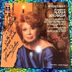 May include: A vintage vinyl record album cover featuring Beverly Sills. The cover has a portrait of Sills in a blue dress, with text including "Maria Stuarda" and "London Philharmonic Orchestra." The album is signed. The cover is digitally remastered.