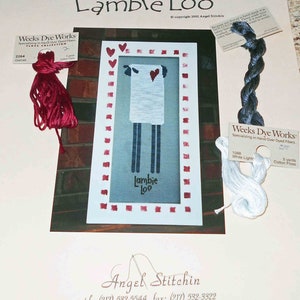 May include: Cross stitch pattern for a white lamb with red hearts and the text "Lambie Loo" in a white frame. The pattern includes floss colors from Weeks Dye Works in garnet, white light, and cotton floss.