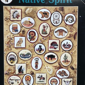 May include: A cross-stitch pattern booklet titled "Native Spirit" by Michael Adams. The cover features a variety of Native American themed designs, including dreamcatchers, teepees, and buffalo. The booklet is published by Dimensions.