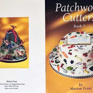 May include: A book titled "Patchwork Cutters Book 7" by Marion Frost. The cover features a white cake decorated with colorful fondant designs, including cherries, carrots, and a book with the words "Happy Birthday" and "Sweet One".