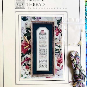 May include: A cross stitch pattern booklet titled "The Drawn Thread" with a floral design on the cover. The pattern is called "The Wildflower Garden" and features a small house with a garden. The booklet includes a price tag of $26.00.