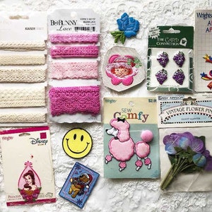 May include: Assortment of iron-on patches featuring various themes, including Disney characters, flowers, a poodle, a smiley face, and a chick.  The patches are packaged on white card stock with the brand name "Wrights" printed on the packaging.  The patches are ideal for adding a personal touch to clothing, bags, and other fabric items.
