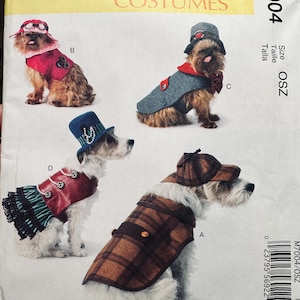 May include: McCall's Costumes pattern M7004 featuring dog costumes. The pattern includes designs for a plaid coat and cap, a red vest with a hat, a gray coat with a hat, and a red vest with a skirt and top hat.