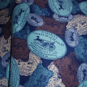 May include: A blue and brown fabric with a repeating pattern of oval-shaped labels. The labels feature the text "St. Charles Livery & Sale Stables" and "Jackson & Devore 117-119, 121, 123, 125 3: ATB Between Smithfielorwood Sts Pittsburgh, PA".