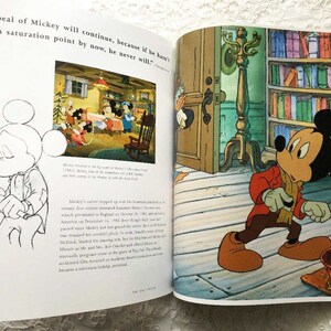 May include: A black and white illustration of Mickey Mouse holding a cane. The image is from a book about the history of Mickey Mouse.
