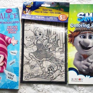 May include: Three coloring books featuring popular children's characters. The first book is a Disney Alice in Wonderland book with a pink and white Cheshire Cat on the cover. The second book is a black and white coloring book with a girl in a dress and a dog. The third book is a Smurfs coloring book with a blue Smurf and a red-hatted Smurf on the cover. The Smurfs book says "Coloring & Activity Book" and "Includes Room Sign on back cover!"