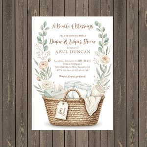 May include: A baby shower invitation with the text "A Bundle of Blessings." The invitation features a watercolour illustration of a wicker basket filled with nappies, wipes, and a blanket, surrounded by floral accents. The invitation is for April Duncan.