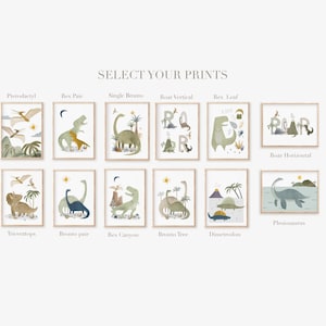 May include: A collection of framed dinosaur art prints. The prints feature watercolor illustrations of various dinosaurs, including Pterodactyls, Triceratops, and Brontos, in a soft, muted color palette. Text at the top reads "SELECT YOUR PRINTS".