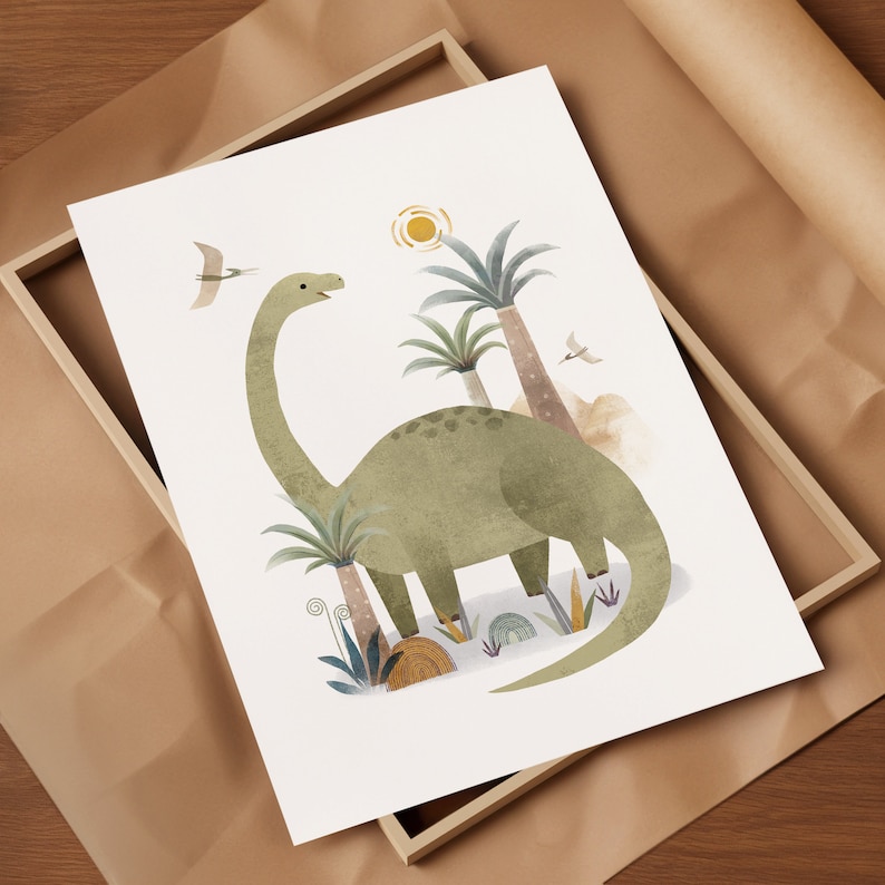 May include: A framed art print featuring a green Brontosaurus dinosaur with a long neck, set against a backdrop of palm trees, a sun, and flying birds. The illustration has a soft, watercolor style, perfect for a nursery or children's room.