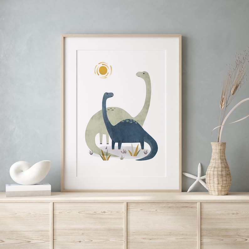 May include: A framed print of two blue and green dinosaurs with a yellow sun in the background.