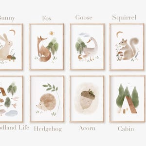 May include: Set of eight watercolor illustrations featuring woodland animals and nature scenes. The prints include a bunny, fox, goose, squirrel, woodland life, hedgehog, acorn, and cabin.