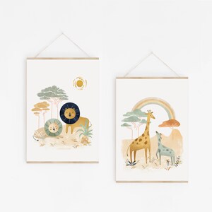 May include: Two printable art prints featuring illustrations of animals in a jungle setting. The first print shows a lion and a lion cub in a green jungle with a yellow sun. The second print shows a giraffe and a smaller giraffe in a green jungle with a rainbow.